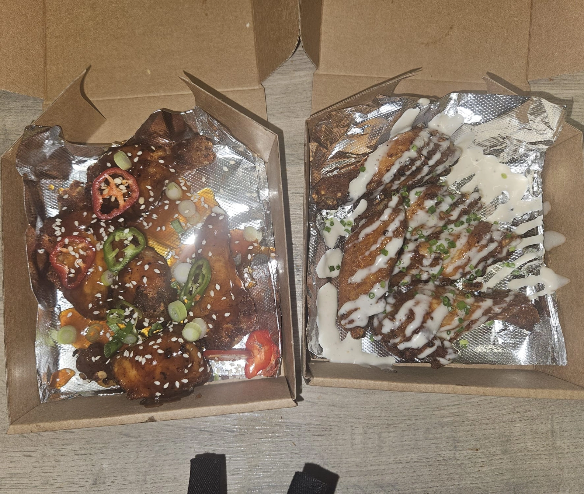 Korean chicken wings topped with chilli peppers, spring onions and sesame seeds